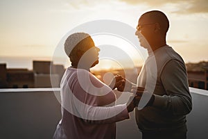 Happy black couple dancing outdoors at summer sunset - Focus on man face