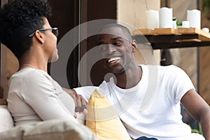 Happy black couple have fun talking relaxing in cafe