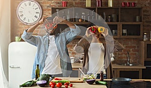 Happy black couple having fun in kitchen