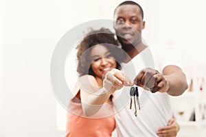 Happy black couple holding keys of their new home