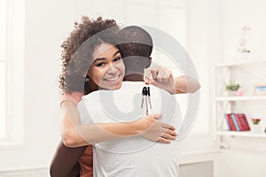 Happy black couple holding keys of their new home