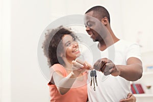 Happy black couple holding keys of their new home