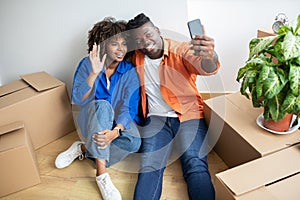 Happy Black Couple Making Video Call After Moving To New Home