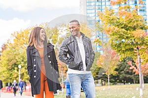 Happy black couple walking at park