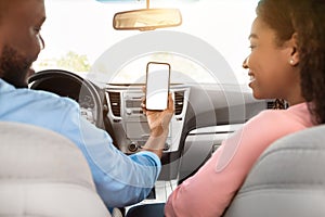 Happy black driver using showing smartphone with empty screen