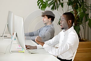 Happy black employee excited by online win or good result