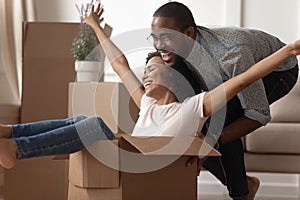 Happy black family couple having fun with carton boxes.