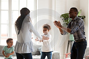 Happy black family play hide and seek at home together
