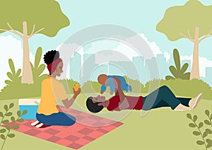 Happy black family playing with their baby in the city park