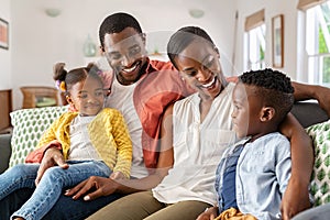 Happy black family playing together at home