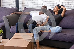 Happy black family relax with small dog moving in together