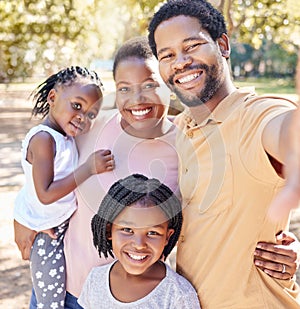 Happy black family take a selfie in nature on a holiday vacation trip together enjoy quality time at a kids park. Smile