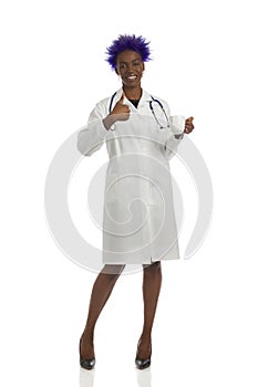 Happy Black Female Doctor Standing With White Cup And Showing Thumb Up. Full Length Isolated