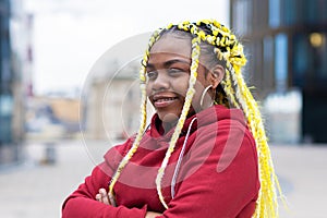 Happy black girl with braids, dreadlocks, yellow kanekalon curls, creative hai