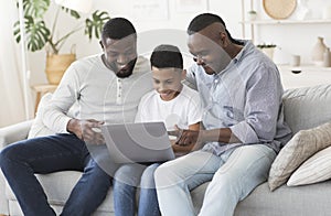 Happy Black Grandfather, Father And Little Son Using Laptop At Home