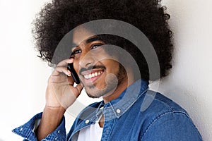 Happy black guy using mobile pone