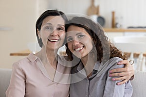 Happy black haired mature mother and daughter woman head shot