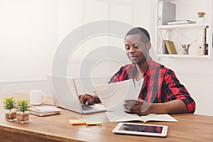 Happy black happy businessman in office, work with laptop