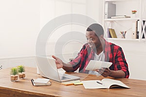 Happy black happy businessman in office, work with laptop