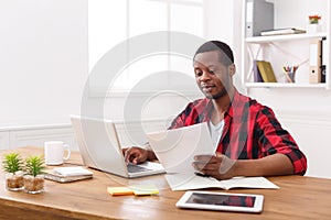 Happy black happy businessman in office, work with laptop