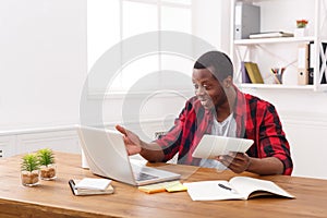 Happy black happy businessman in office, work with laptop