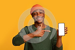 Happy Black Hipster Guy Holding And Pointing On Smartphone With White Screen
