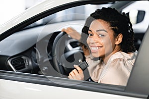 Happy Black Lady Doing Test Drive Posing Sitting In Automobile