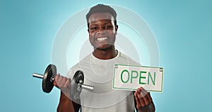 Happy black man, dumbbell and open sign for gym, fitness or motivation against a blue background. Portrait of active