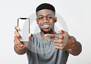 Happy black man holding latest slim smartphone photo