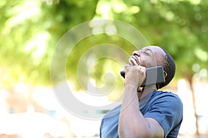 Happy black man laughing talking on phone