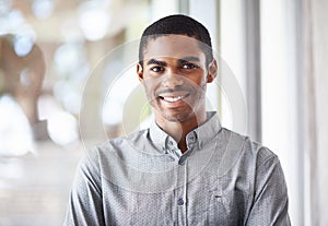 Happy black man, portrait and window with confidence or ambition for career, job or creative startup at office. Face of