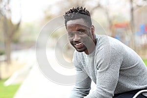 Happy black man posing looking at camera on a park
