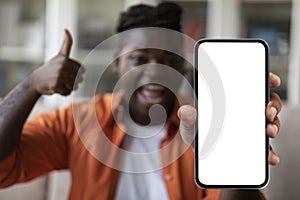 Happy Black Man Showing Big Phone With Empty Screen