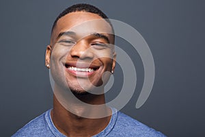 Happy black man smiling on gray background