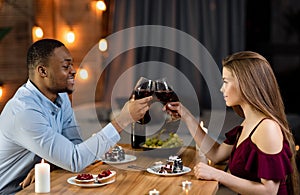 Happy Black Man And White Woman Having Romantic Dinner In Restaurant