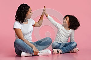 Happy Black Mom And Daughter Giving High Five To Each Other