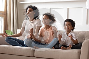 Happy black mom practice yoga with little kids