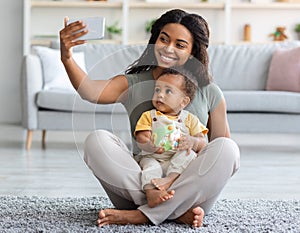 Happy Black Mom Taking Selfie With Her Adorable Infant Baby At Home