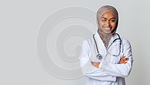 Happy Black Muslim Female Doctor Student In Hijab And White Coat