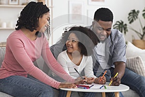 Happy Black Parents Drawing With Their Little Daughter At Home