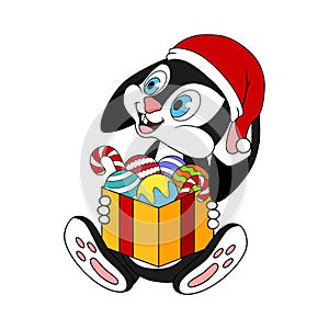 Happy black rabbit sitting and holding a full box of christmas balls and sweets. Cartoon bunny or hare in santa hat