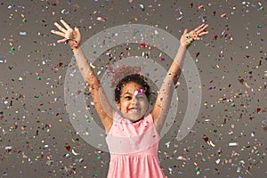 Happy black small girl at white studio background