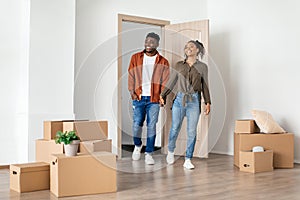 Happy Black Spouses Holding Hands Entering New Home