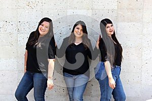 Happy black straight hair latin adult sisters dressed in black for family photo shoot in harmony and joy