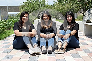 Happy black straight hair latin adult sisters dressed in black for family photo shoot in harmony and joy