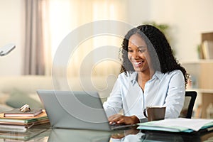 Happy black tele worker working online at home