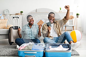 Happy Black Travelers Gesturing Yes Posing With Travel Tickets Indoors