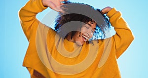 Happy black woman, dance and beauty in studio by blue background for fashion, smile or wellness. Young gen z student