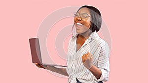 Happy Black Woman Holding Laptop Celebrating Victory In Studio, Panorama