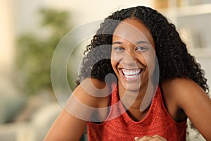 Happy black woman with perfect smile looking at you